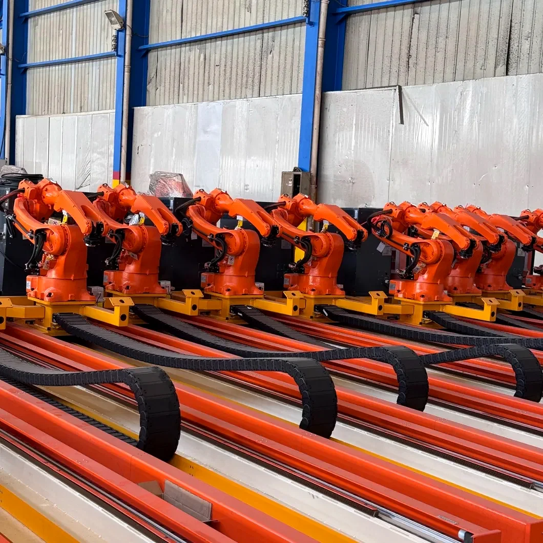 Rows of orange rail-mounted welding robot systems in production