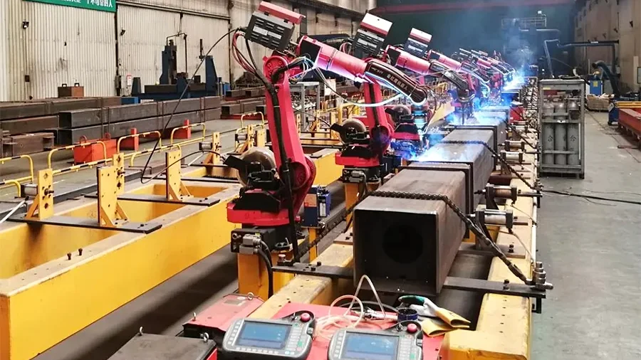 Rows of welding robots operating on a structural steel production line in a Honglu factory